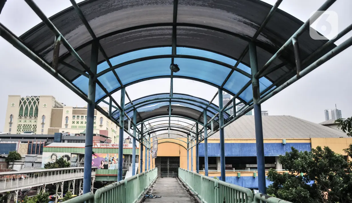 Kondisi JPO sebagai akses pengunjung ke Blok G Pasar Tanah Abang, Jakarta, Rabu (30/11/2022). Datangnya pandemi Covid-19 pada 2020 memperparah kondisi Blok G Pasar Tanah Abang. Menurut pedagang, sejak satu tahun lalu semua pedagang yang berada di lantai 2 dan 3 terpaksa dipindahkan ke lantai bawah akibat sepinya pedagang yang membuka atau menyewa kios. (merdeka.com/Iqbal S. Nugroho)