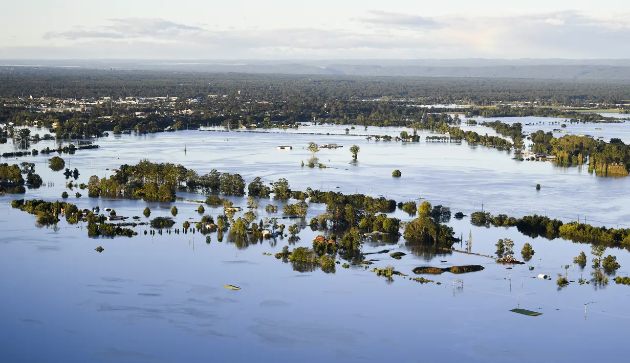 Air banjir menutupi wilayah yang luas di Windsor barat laut Sydney, Rabu (24/3/2021).  Sekitar 18.000 penduduk negara bagian terpadat di Australia telah meninggalkan rumah mereka sejak pekan lalu, dengan peringatan banjir dapat berlanjut hingga April. (Lukas Coch/Pool Photo via AP)