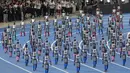 Robot-robot berjalan saat upacara pembukaan World Humanoid Robot Games di Beijing, Sabtu, 22 Agustus 2026. (Foto AP/Achmad Ibrahim)