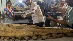 Ahli paleontologi Peru Aldo Benites dan Jeri Ramon, Direktur Peruvian University of San Marcos, menjelaskan rincian penemuan fosil paus sperma prasejarah "diawetkan utuh selama tujuh juta tahun" di National Natural History di Lima, Rabu (15/2/2023). Fosil tersebut ditemukan di gurun Ocucaje, sekitar 350 km selatan ibu kota Peru. (Cris BOURONCLE / AFP)