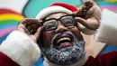 Aktor Rodrigo Franca berperan sebagai Papai Negro atau Sinterklas Hitam dalam acara Natal sekolah yang diselenggarakan oleh LSM Favela Mundo di favela City of God, Rio de Janeiro, Brasil, Senin (11/12/2023). (AP Photo/Bruna Prado)