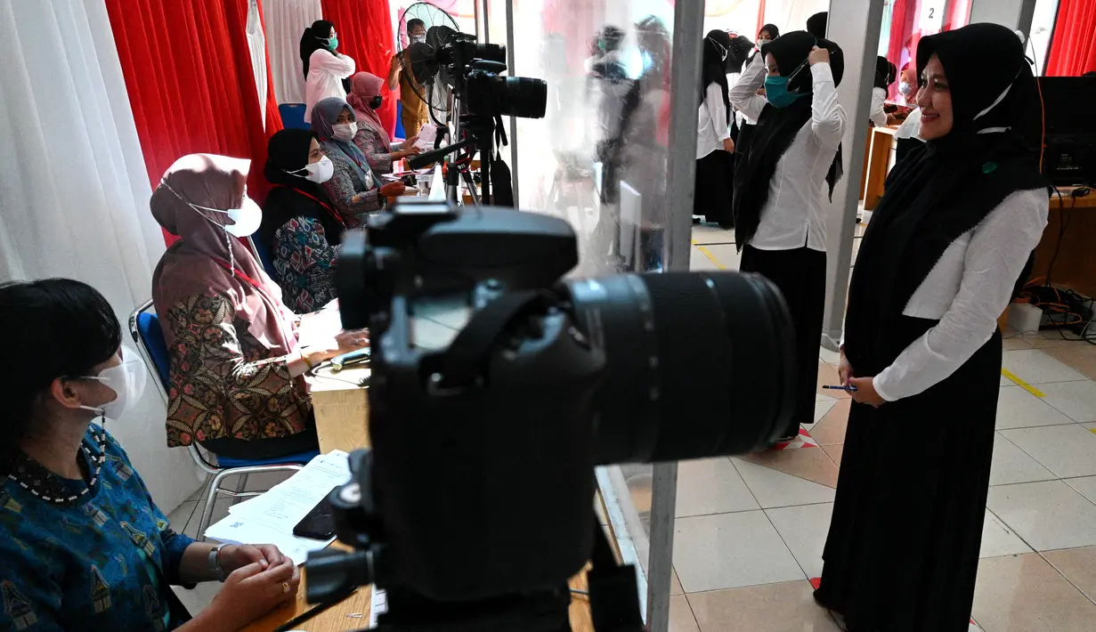 Peserta melakukan registrasi sebelum mengikuti tes di Banda Aceh  (14/9/2021). Tes SKD menerapkan protokol kesehatan yang ketat. (AFP/Chaideer Mahyuddin)
