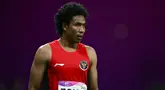 Pelari asal Indonesia, Lalu Muhammad Zohri bereaksi usai berlaga pada final 100m putra Asian Games 2023 di Hangzhou, Provinsi Zhejiang, China, Sabtu (30/9/2023). (Manan VATSYAYANA/AFP)