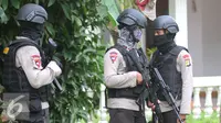 Petugas Kepolisian Brimob berjaga disekitar area rumah terduga teroris di Setu, Tangerang Selatan, Rabu (21/12). Sebelum membekuk terduga, polisi sudah memperingatkan mereka agar menyerahkan diri. (Liputan6.com/Helmi Affandi)