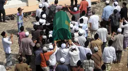Sejumlah orang menggotong keranda jenazah Ali Mustafa Yaqub  menuju rumah duka di Pisangan Barat, Ciputat, (28/4). Ali Mustafa dikenal sebagai ulama moderat dan pemandu para pemimpin dunia saat berkunjung ke Masjid Istiqlal. (Liputan6.com/Helmi Afandi)