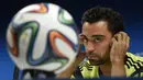 Xavi menyebut bahwa Spanyol tidak perlu mengubah gaya bermain yang sudah diterapkan dalam beberapa tahun terakhir. Mengubah gaya bermain Spanyol, menurut Xavi, adalah sebuah kesalahan, Brasil, Jumat (13/6/2014) (AFP Photo/LLUIS GENE).
