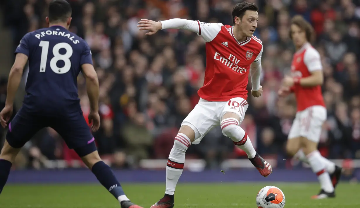 Pemain Arsenal, Mesut Ozil, mengontrol bola saat melawan West Ham United pada laga Liga Inggris di Stadion Emirates, Sabtu, (7/3/2020). (AP Photo/Matt Dunham)