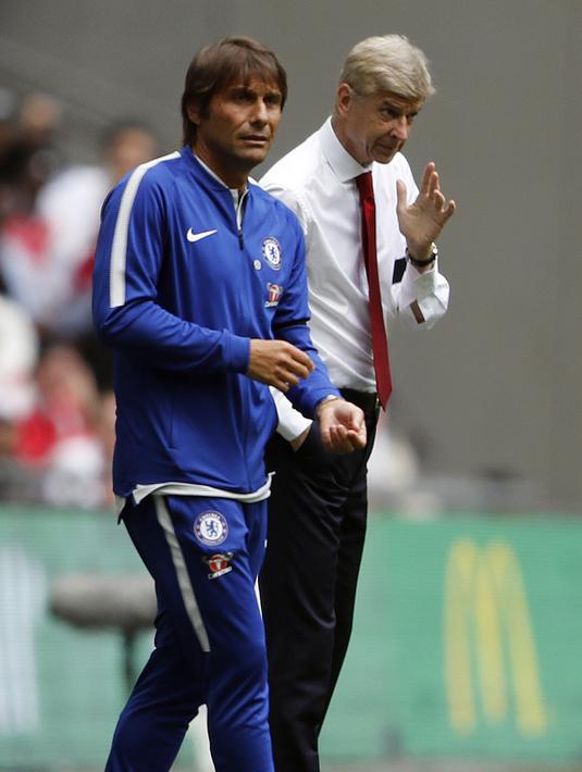 Pelatih Arsenal, Arsene Wenger (kanan) dengan tenang memberikan masukan kepadan anak asuhnya saat laga melawan Chelsea pada Community Shield 2017  di Wembley Stadium, London, (6/8/2017). Arsenal menang lewat adu penalti 4-1. (AFP/Frank Augstein)