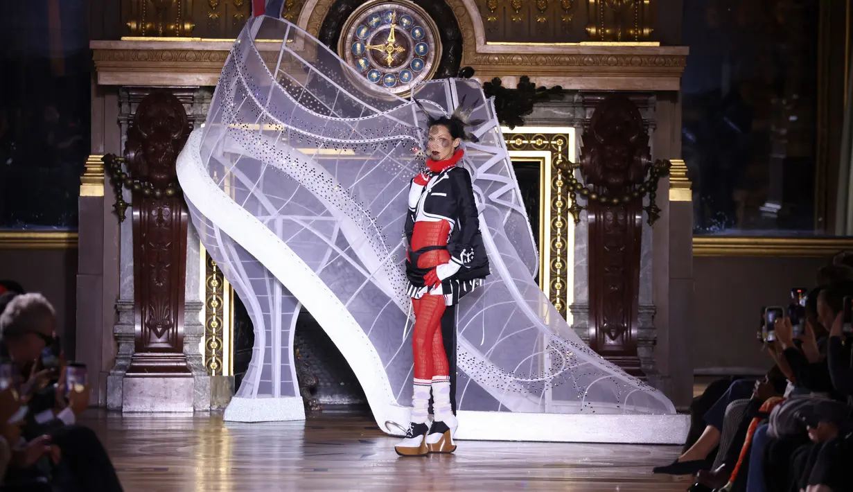 Bella Hadid mempersembahkan kreasi Thom Browne saat peragaan busana Musim Semi-Musim Panas 2023 sebagai bagian dari Paris Womenswear Fashion Week, Paris, Prancis, 3 Oktober 2022. Bella memadukan blazer hitam putih yang didesain agar terlihat seperti jaket tuksedo. (Photo by Vianney Le Caer/Invision/AP)