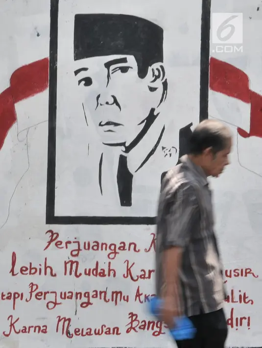 Pejalan kaki melintas di depan mural Bung Karno di Jalan Kolonel Sugiono, Jakarta, Selasa (13/8/2019). Mural dalam rangka menyambut Hari Kemerdekaan pada 17 Agustus itu sekaligus untuk mempercantik jalanan Ibu Kota. (merdeka.com/Iqbal S Nugroho)