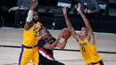 Pebasket Portland Trailblazers, CJ McCollum, berebut bola dengan pebasket LA Lakers pada babak pertama playoff NBA 2020 di AdventHealth Arena, Rabu (19/8/2020). LA Lakers takluk 93-100 atas Portland Trailblazers. (AFP/Ashley Landis-Pool/Getty Images)