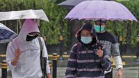 Warga menggunakan payung beraktivitas di kawasan Bundaran HI, Jakarta, Minggu (24/1/2021). Badan Meteorologi Klimatologi dan Geofisika (BMKG) mencatat sebagian besar wilayah Indonesia telah memasuki masa puncak musim hujan. (Liputan6.com/Herman Zakharia)