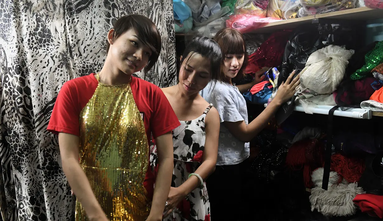Jessica Nguyen dan rekan sesama transgender usai suntik hormon di tokonya, Vietnam (30/3). Komunitas transgender di Vietnam sudah tidak perlu lagi ke dokter spesialis untuk suntik hormon, mereka bisa melakukan sendiri. (AFP Photo/Hoang Dinh Nam)
