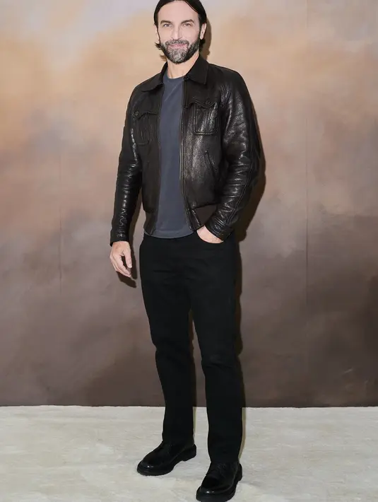 Nicolas Ghesquiere menampilkan kesan kasual yang menawan. Ia mengenakan kaus abu-abu polos, dilayer dengan jaket kulit, dan dipadu dengan celana panjang jeans, dan sepatu hitam. Foto: Document/Louis Vuitton.