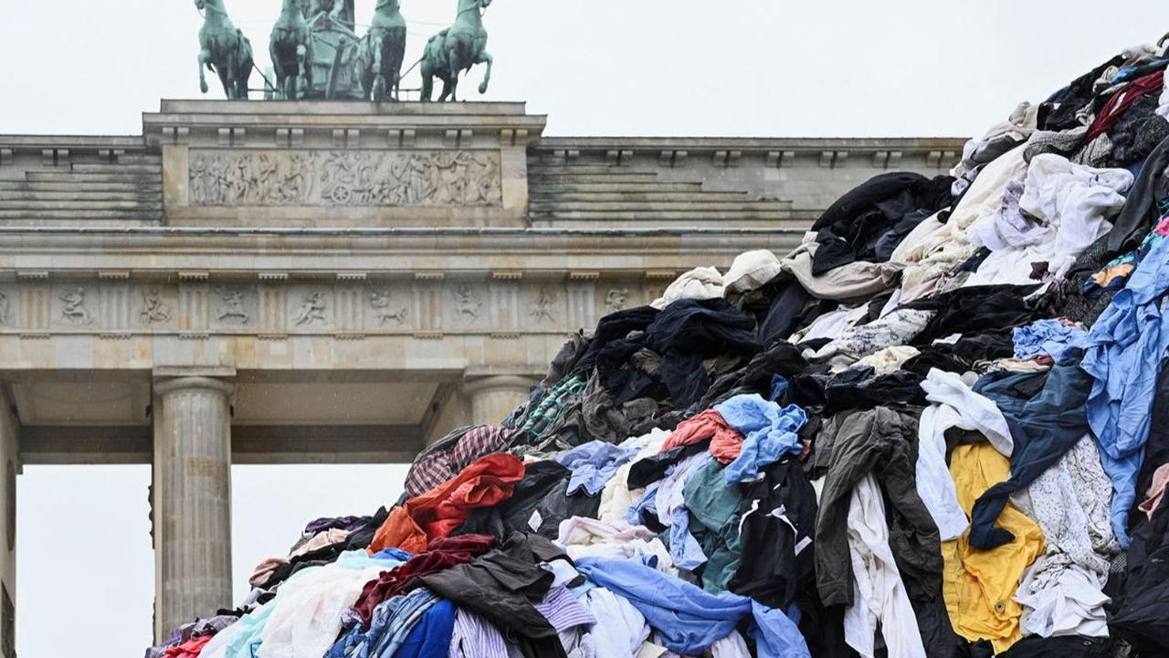 Gunungan sampah pakaian bekas dipajang oleh aktivis lingkungan Greenpeace di depan Gerbang Brandenburg, Berlin, Jerman, pada 5 Februari 2024. Aksi ini dilakukan untuk menentang tren fast fashion yang memiliki dampak buruk bagi lingkungan.&nbsp;REUTERS/Ann