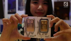 Petugas menunjukan dummy emas batangan saat pameran di Jakarta, Jumat (23/8/2019). Harga emas produksi PT Aneka Tambang Tbk (Antam) atau emas Antam turun Rp 4.000 menjadi Rp 751 ribu per gram, pada perdagangan Jumat (23/8/2019).  (Liputan6.com/Angga Yuniar)