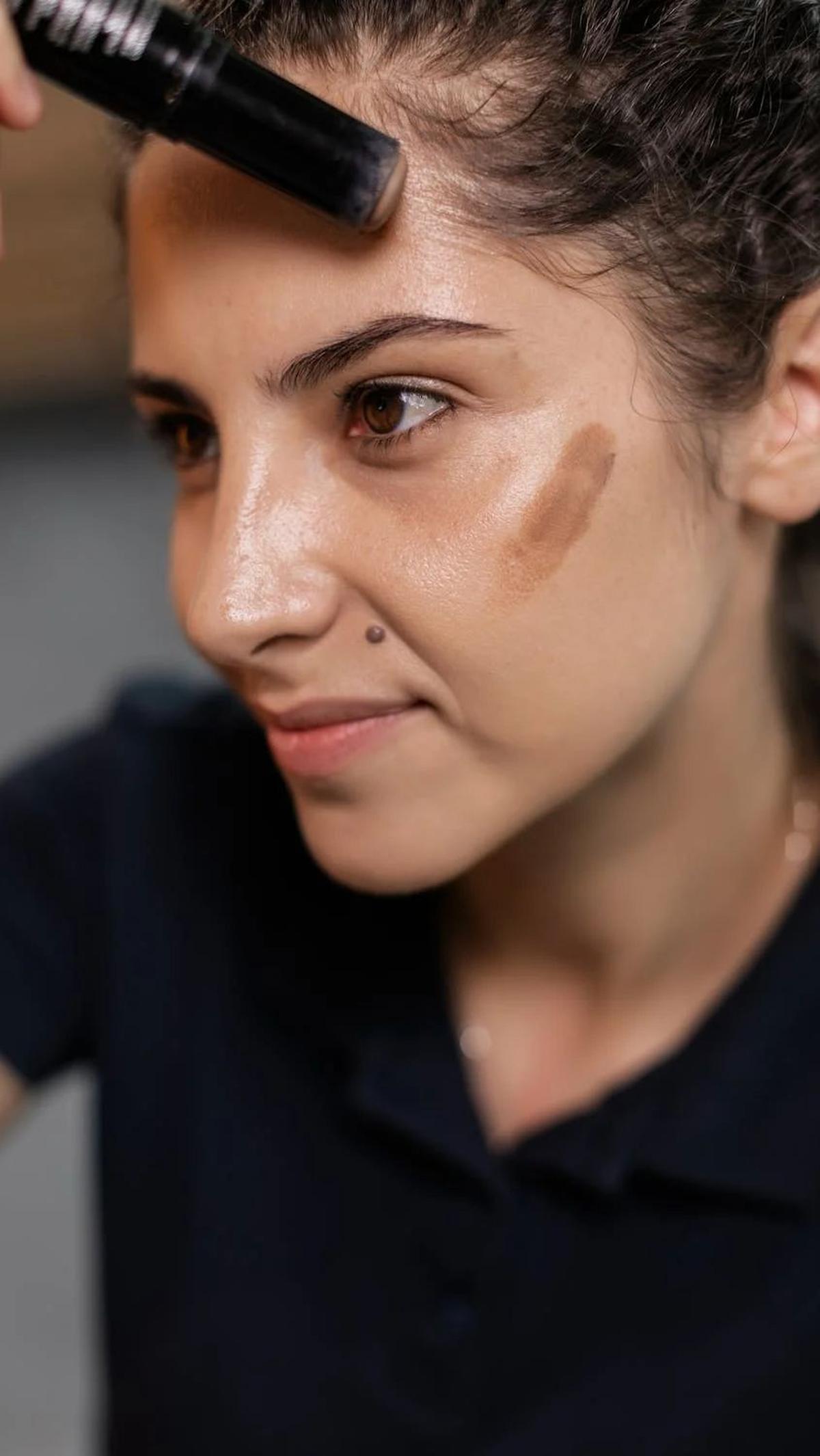 3. Highlight:<br>Setelah contour, aplikasikan highlighter pada area yang memantulkan cahaya, seperti dahi, pangkal hidung, ujung hidung, tulang pipi, busur cupid, dan sekitar mata.