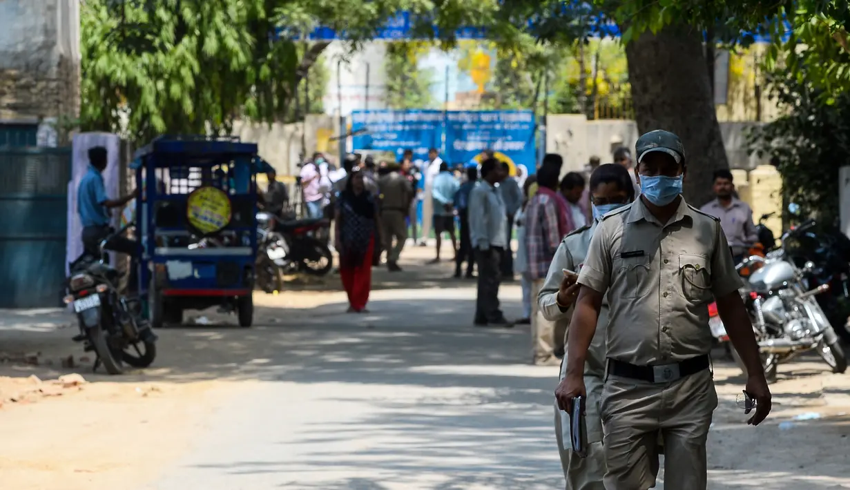 Polisi India berada di lokasi kebocoran gas di sebuah depot kontainer di New Delhi, Sabtu (6/5). Polisi meyakini, gas tersebut adalah kloro metal piridin, cairan kimia yang digunakan dalam industri pestisida dan insektisida. (Chandan KHANNA/AFP)