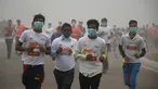 Peserta lari New Delhi 10K menggunakan masker tetap mengikuti lomba ditengah-tengah kabut polusi yang menimpa kota New Delhi, India (6/11). Kabut asap ini diklaim sebagai kabut terparah yang dialami oleh New Delhi dalam 17 tahun. (AFP/Dominique Faget)