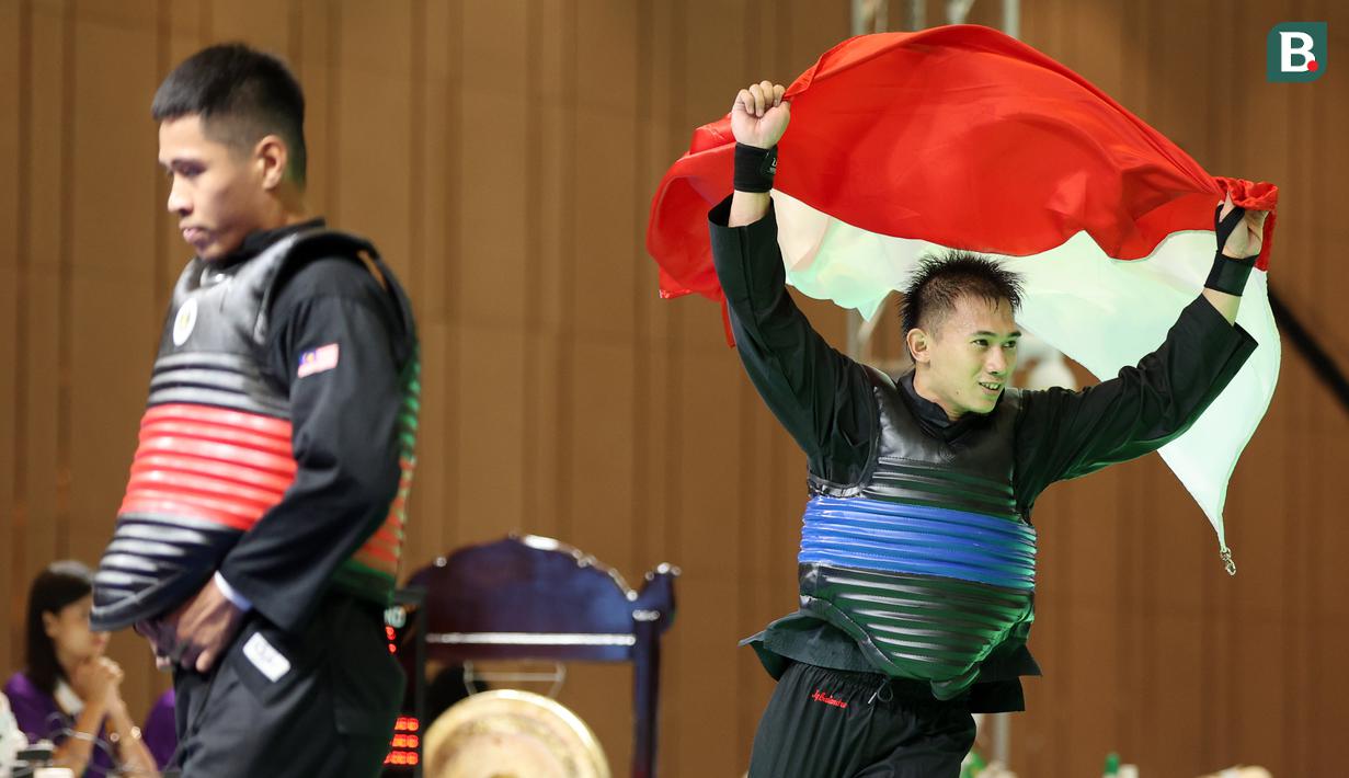 Pesilat Indonesia Iqbal Candra Pratama tak mampu menutupi kebahagiaanya setelah berhasil meraih medali emas pertamanya di ajang SEA Games. (Bola.com/Abdul Aziz)