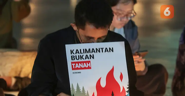 Sejumlah poster yang dibawa simpatisan masyarakat turut mewarnai aksi solidaritas dan doa bersama untuk korban kebakaran hutan dan lahan (karhutla) di Tugu Proklamasi, Jakarta, Senin malam (19/10/2026). (KLY/Budy Santoso)
