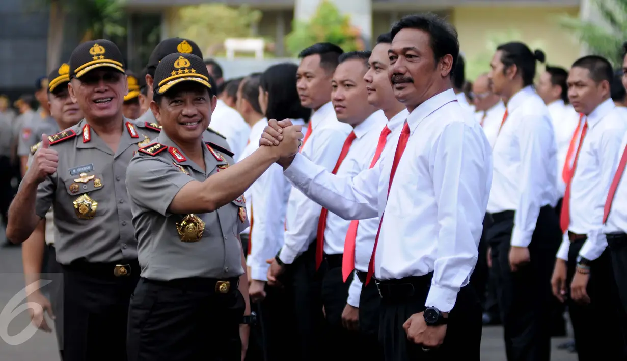 Kapolri Jenderal Tito Karnavian melakukan salam komando dengan salah satu anggota kepolisian yang mendapat penghargaan karena berhasil mengungkap kasus perampokan Pulomas dengan cepat, Jakarta, Rabu (18/1). (Liputan6.com/Gempur M Surya)
