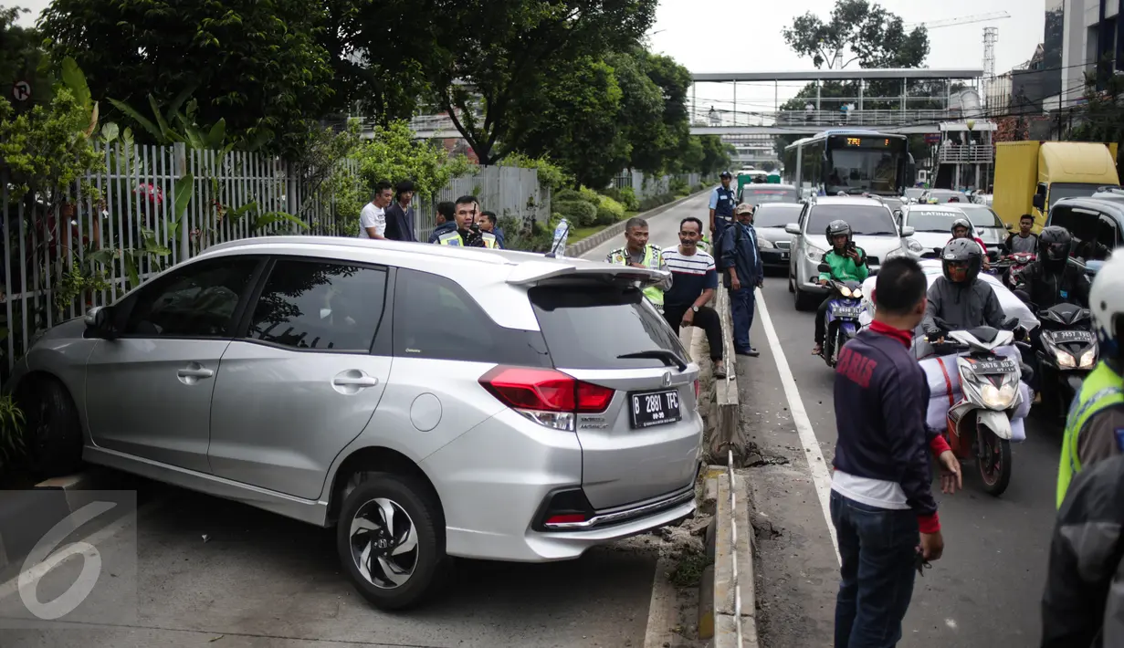 Arus lalu lintas di lokasi mobil yang menabrak separator busway matraman arah kampung melayu, Jakarta, Sabtu (25/2). Akibat kecelakaan ini lalu lintas kawasan jalan matraman mengarah kampung melayu tersendat. (Liputan6.com/Faizal Fanani)