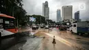 Kondisi lalu lintas saat terjadi genangan air akibat kebocoran saluran pipa air di kawasan Bundaran Hotel Indonesia (HI), Jakarta, Selasa (11/10/2022). Kebocoran pipa air diduga terimbas proyek revitalisasi Halte Bundaran Hotel Indonesia. (Liputan6.com/Faizal Fanani)