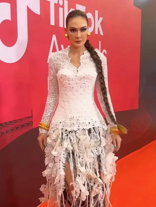Luna Maya mengenakan kebaya brokat warna putih yang dimodifikasi dengan aksen fringe yang apik dari Toton The Label. [@lunamaya]