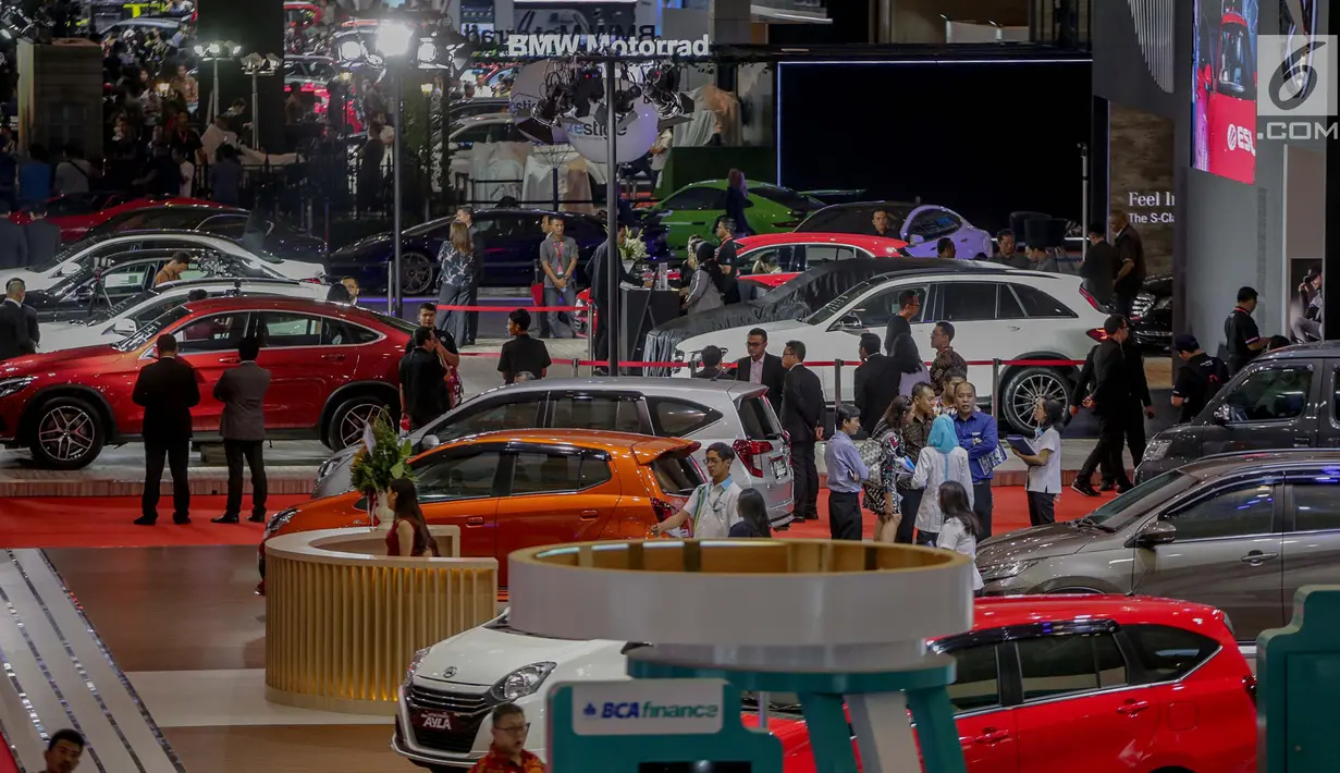 Pengunjung melihat mobil yang dipamerkan saat pembukaan Indonesia International Motor Show (IIMS 2019) di JIExpo Kemayoran, Jakarta, Kamis (25/4). Pameran industri otomotif tersebut berlangsung 25 April - 5 Mei 2019. (Liputan6.com/Faizal Fanani)
