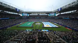 Berbeda dari bendera negara peserta lainnya, bendera milik Arab Saudi dibentangkan tanpa menyentuh rumput lapangan pertandingan. (AFP/Getty Images/Molly Darlington)