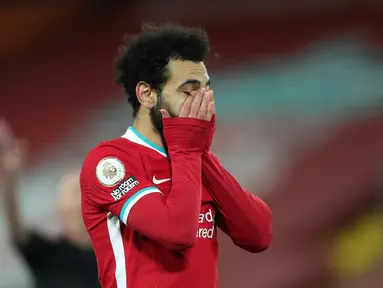 Reaksi gelandang Liverpool, Mohamed Salah saat menjamu Burnley pada laga pekan ke-19 Liga Inggris 2020-2021 di Stadion Anfield, Jumat dini hari WIB (22/1/2021). Liverpool kalah tipis 0-1 atas Burnley sekaligus menelan kekalahan ketiga musim ini. (Clive Brunskill/POOL/AFP)