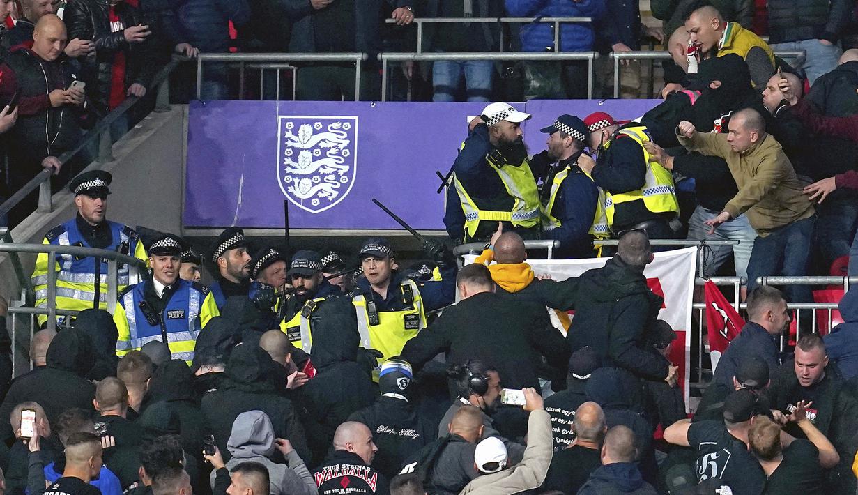 Menjelang laga dimulai terjadi bentrokan saat para pendukung Hongaria mencemooh para pendukung Inggris. Petugas keamanan pun turun tangan untuk meredakan situasi. (PA via AP/Nick Potts)