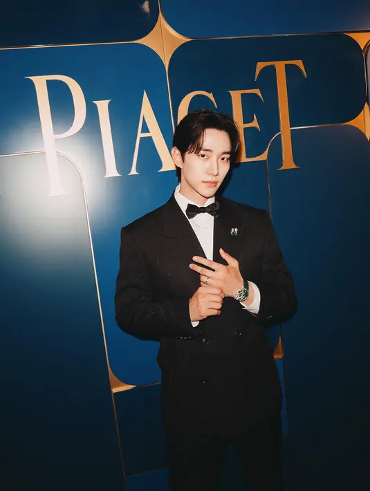 Lee Jun-ho lengkapi busana klasik necisnya dengan jam tangan Altiplano Arty Pop. Jam tangan emas putih ini bertahtakan zamrud, berlian, chrysoprase, dan malachite. Dipadu dengan Cincin Prisma Grafis dan Kancing Manset, keduanya berbahan emas putih dengan zamrud dan berlian, serta anting-anting Treasure berbahan emas putih, berlian, dan zamrud. [Piaget]