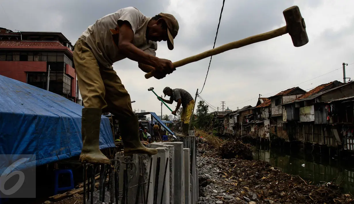 Pekerja menggarap pemasangan turap di kawasan Kali Roxy, Jakarta, Senin (14/11). Pemasangan dinding turap tersebut guna mengantisipasi luapan air kali saat musim penghujan. (Liputan6.com/Faizal Fanani)