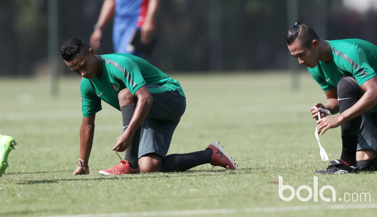 Osvaldo Haay dan Ryuji Utomo (kanan) kompak mengikat tali sepatu saat sesi latihan Timnas U-22 Indonesia di Lapangan SPH, Karawaci, Jumat (17/3/2017). Latihan ini adalah persiapan laga persahabatan melawan Mynmar. (Bola.com/Nicklas Hanoatubun)