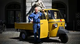 Seorang pria berpose dengan kendaraan Ape miliknya saat pameran memperingati 70 tahun Ape di Aosta, Italia utara (1/7). Piaggio Ape sendiri merupakan salah satu karya Corradino D’Ascanio insinyur yang juga merancang Vespa. (AFP Photo/Marco Bertorello)