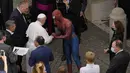 Paus Fransiskus bertemu Spider-Man pada akhir audiensi umum mingguan dengan jumlah umat terbatas di San Damaso Courtyard, Vatikan, Rabu (23/6/2021). Di akhir audiensi, pria tersebut diperkenalkan kepada Paus Fransiskus dan memberi masker Spider-Man miliknya. (AP Photo/Andrew Medichini)