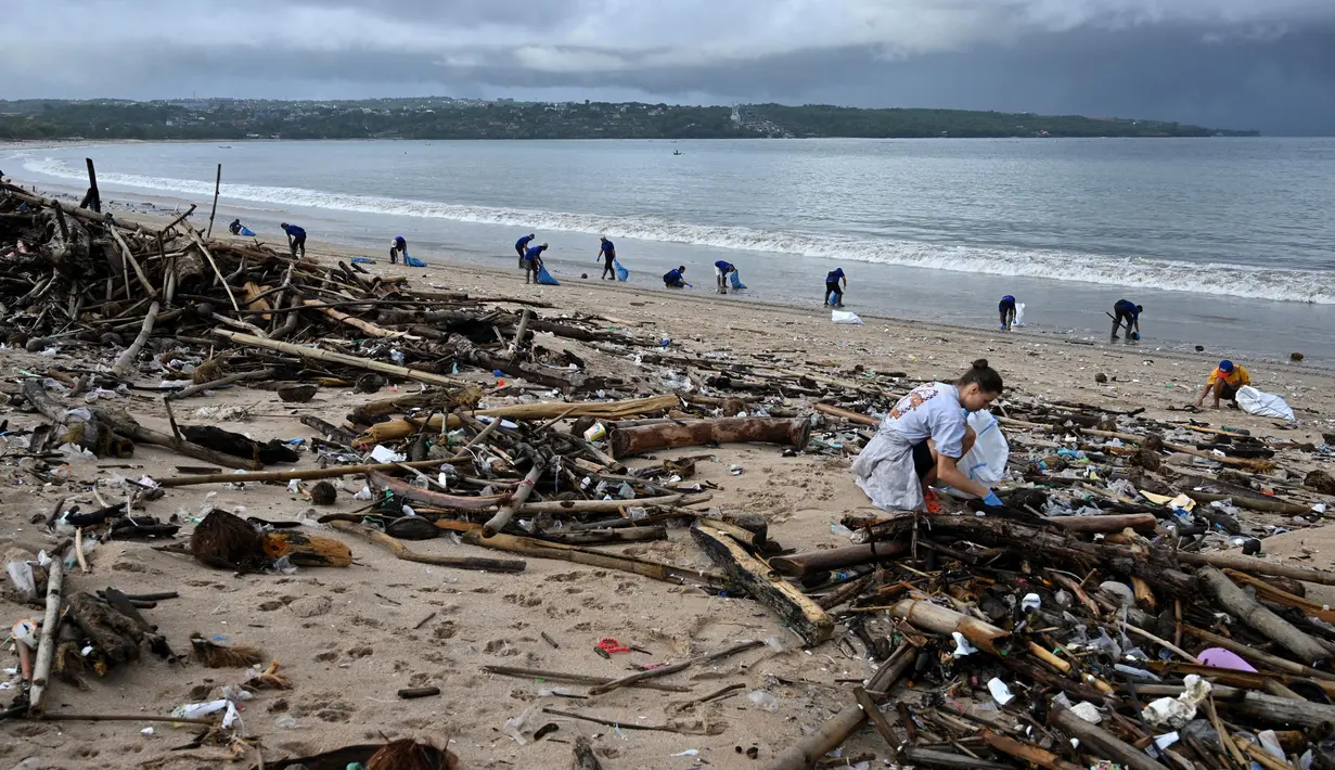 Mereka terdorong untuk ikut membersihkan sampah yang menumpuk di pantai Kedonganan, Badung, Bali. (SONNY TUMBELAKA/AFP)