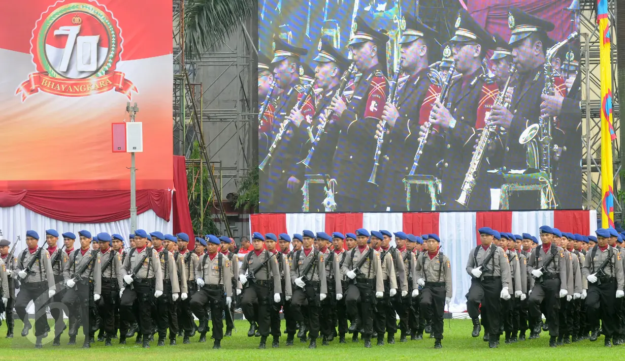 Anggota kepolisian berbaris mengikuti upacara HUT Bhayangkara Polri ke-70 di Lapangan Bhayangkara Mabes Polri, Jakarta, Jumat (1/7). Upacara HUT Bhayangkara ini dipimpin Kapolri Jenderal Pol Badrodin Haiti. (Liputan6.com/Helmi Afandi) 