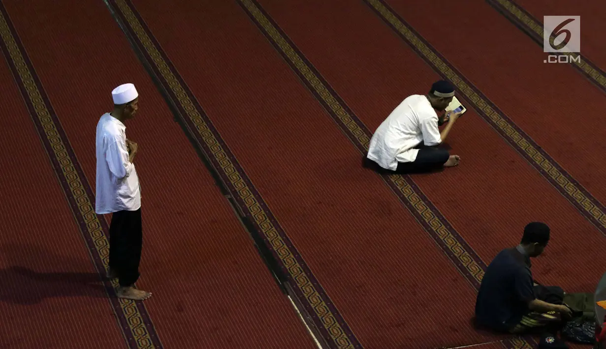 Umat muslim melaksanakan salat dan membaca Al Quran saat malam takbiran di Masjid Istiqlal, Jakarta, Selasa (4/6/2019). Umat muslim akan melaksanakan salat Idul Fitri 1440 Hijriah di Masjid Istiqlal, Jakarta. (Liputan6.com/Helmi Fithriansyah)