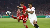 Pemain Bayern Munchen, Thomas Muller, berduel dengan striker Sevilla, Luis Muriel pada laga leg kedua perempat final Liga Champions di Allianz Arena, Kamis (12/4/2018) dini hari WIB. (AP Photo/Matthias Schrader)