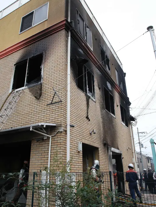 Petugas pemadam kebakaran memeriksa bangunan saat kebakaran melanda studio animasi Kyoto Animation di Kyoto, Jepang, Kamis (18/7/2019). Korban tewas kemungkinan akan bertambah mengingat tidak adanya tanda-tanda kehidupan di dalam studio. (JIJI PRESS/AFP)