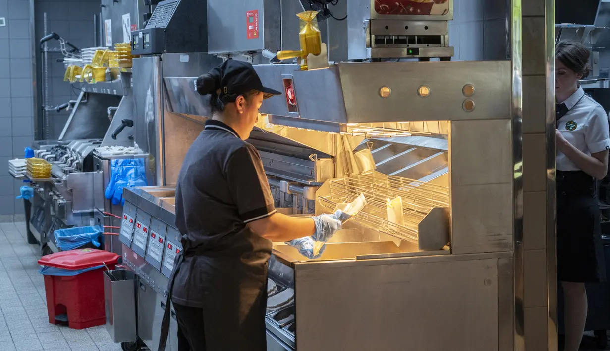 Pekerja bekerja di dapur sebuah restoran cepat saji yang baru dibuka di bekas gerai McDonald's di Bolshaya Bronnaya Street, Moskow, Rusia, 12 Juni 2022. Korporasi menjual cabangnya di Rusia ke salah satu pemegang lisensi lokal setelah Rusia mengirim puluhan ribu tentara ke Ukraina. (AP Photo/Dmitry Serebryakov)