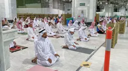 Umat Muslim melaksanakan salat tarawih berjemaah dengan menjaga jarak selama bulan suci Ramadan di Masjidil Haram, Kota Mekkah pada 8 Mei 2020. Otoritas Saudi mengizinkan sejumlah jemaah  memasuki Masjidil Haram untuk melakukan salat selama Ramadan di tengah pandemi virus corona. (STR / AFP)