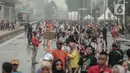 Petugas keamanan berjaga saat warga beraktivitas di car free day (CFD) kawasan Bundaran HI, Jakarta, Minggu (29/12/2019). Kendati tidak seramai saat cerah, warga yang berlari, jalan santai, atau swafoto masih menjadi pemandangan di area CFD usai hujan mengguyur Jakarta. (Liputan6.com/Faizal Fanani)