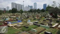 Warga melewati area makam TPU Karet Bivak, Jakarta (2/2). Dinas Pertamanan dan Pemakaman DKI telah menerapkan sistem online dalam pelayanan pemakaman di Ibukota dengan alamat situs pertamananpemakaman.jakarta.go.id. (Liputan6.com/Gempur M Surya)