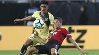 Ander Herrera (kanan) mencoba melewati pemain Club America, Joe Corona pada laga uji coba di University of Phoenix Stadium, Glendale, Arizona, (19/7/2018). MU dan Club America bermain imbang 1-1. (AP/Ralph Freso)