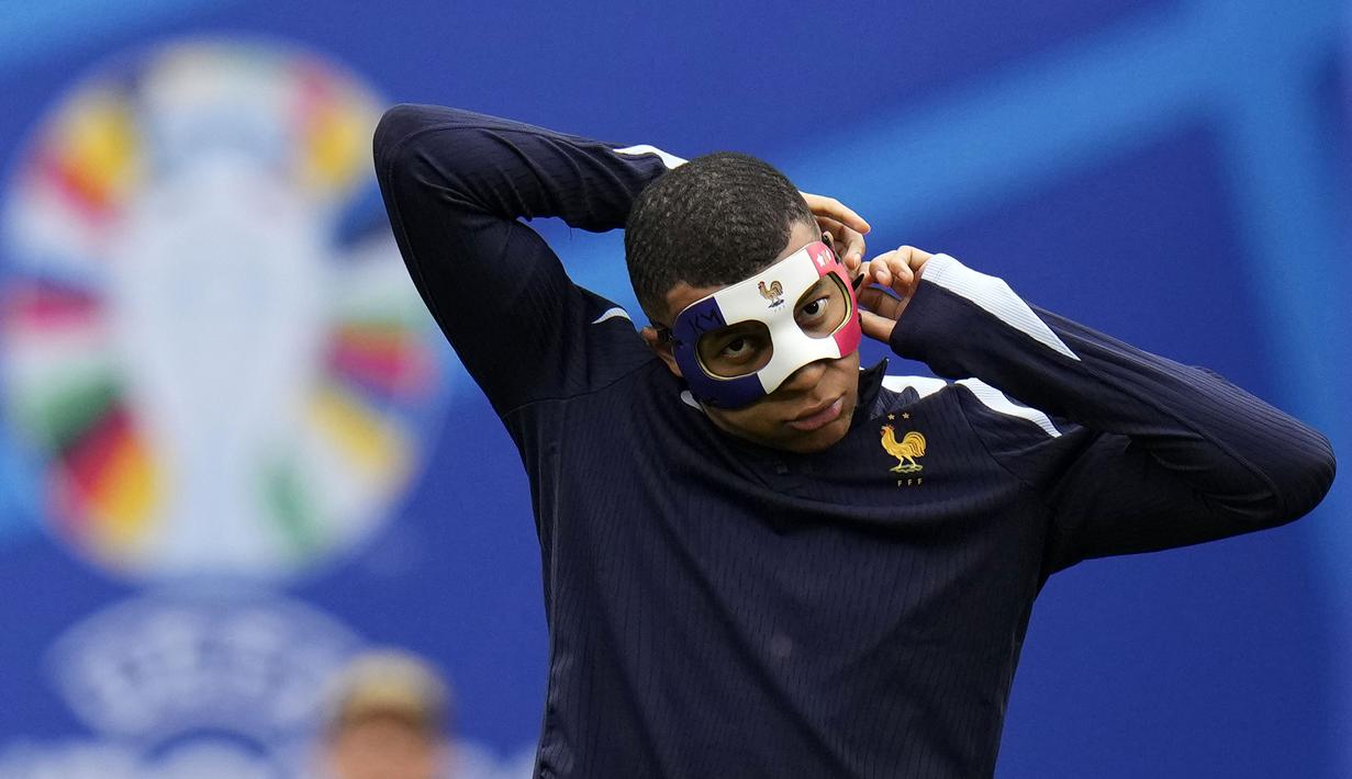 Pemain Prancis, Kylian Mbappe memasang topeng saat sesi latihan jelang laga melawan Belanda pada laga Grup C Euro 2024 di Leipzig Stadium, Leipzig, Jerman, Kamis (20/06/2024) waktu setempat. (AP Photo/Hassan Ammar)