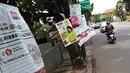 Sejumlah Alat Paraga Kampanye masih terlihat di pinggir Jalan Raya Pasar Minggu, Jakarta, Minggu (14/4). Memasuki masa tenang jelang pelaksanaan Pemilu 2019, sejumlah Alat Paraga Kampanye masih terlihat bertebaran di beberapa ruas jalan. (Liputan6.com/Helmi Fithriansyah)